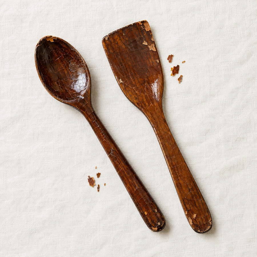 Varnished wooden spoon and spatula with cracked, flaking lacquer