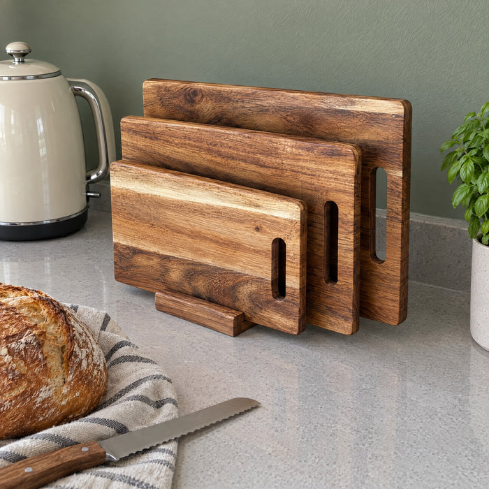 Three acacia boards on a stand next to a kettle