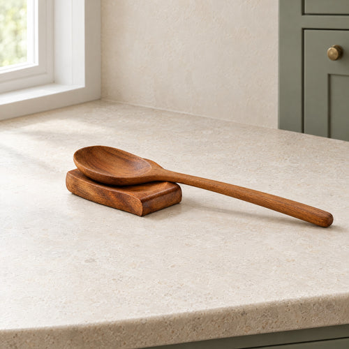 Palm-sized teak spoon rest holding a full-size teak spoon