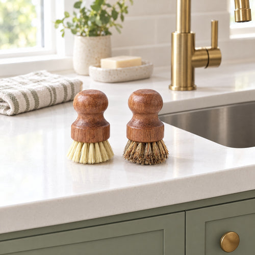Acacia pot brushes with sisal and palm fiber bristles on a clean counter next to the sink